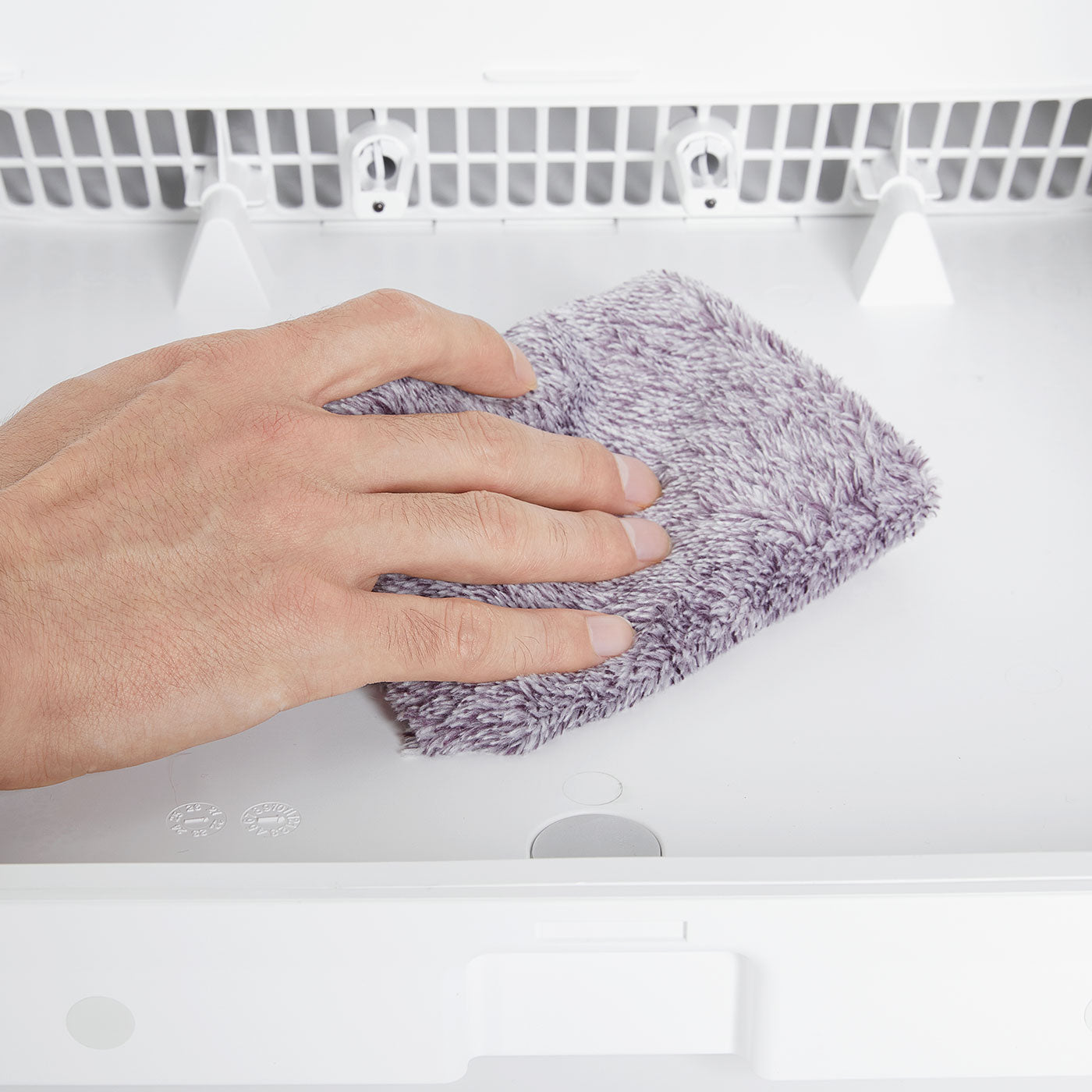 Wiping away water residue inside AirSalon Max Pro Pet Dryer Box to ensure a dry and clean chamber